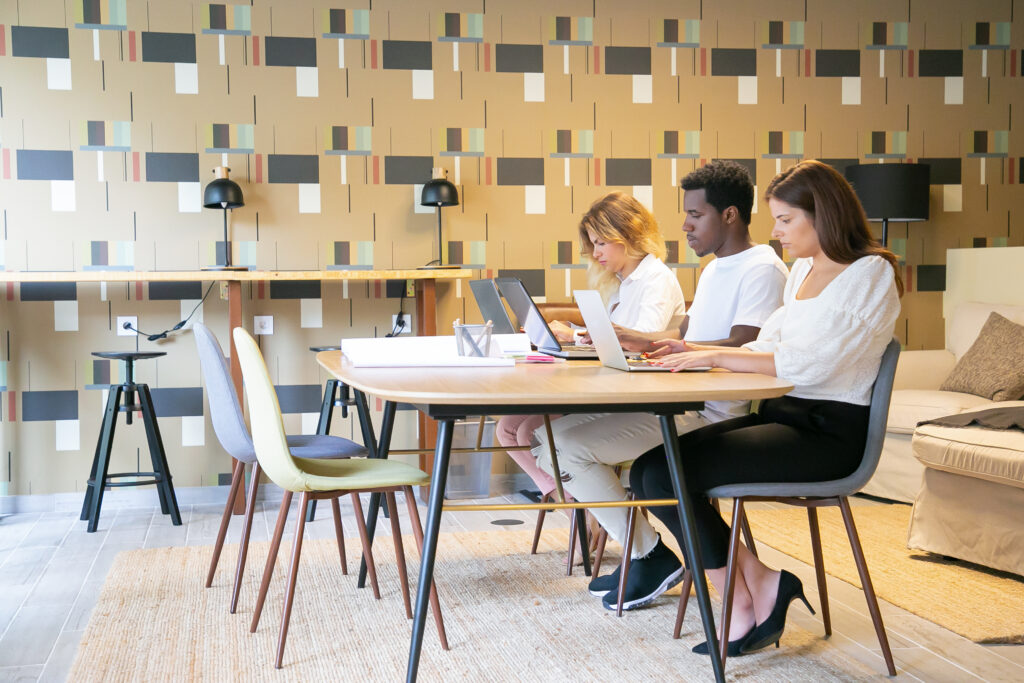 Team of focused designers sitting together at table